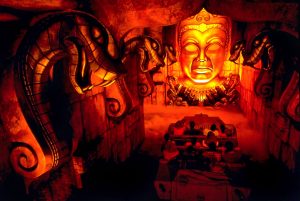 Inside of the Indiana Jones Adventure attraction at Disneyland Resort, we see five large snakes and the face of the idol looking down on a ride vehicle full of passengers.&nbsp;
