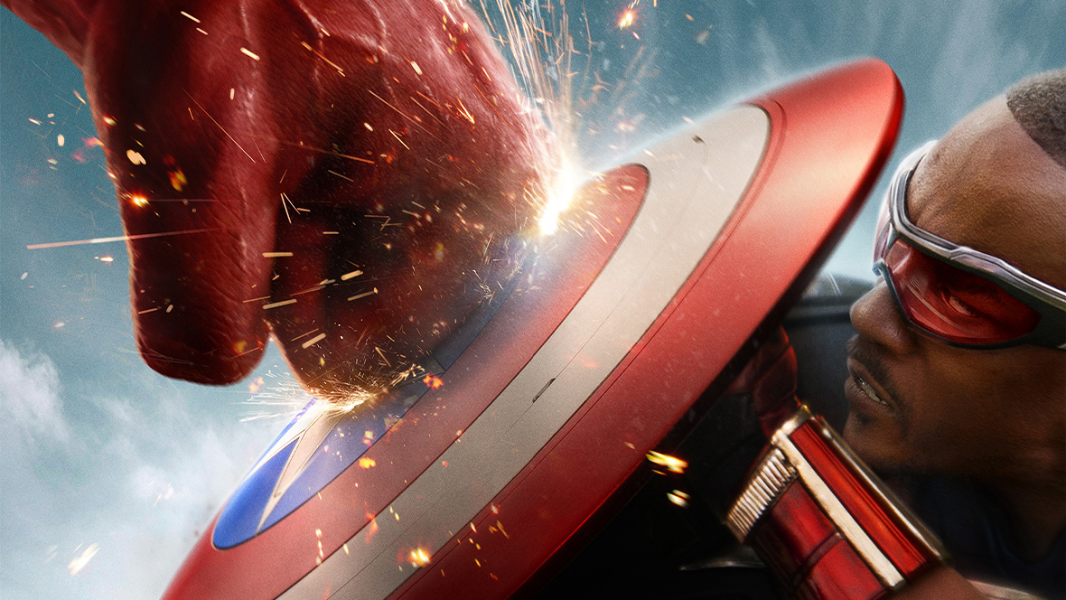 A promotional image for Captain America: Brave New World featuring Sam Wilson as Captain America holding up his shield to block a punch from the Red Hulk. Sparks fly where the fist meets the vibranium shield. Sam wears his signature suit and red goggles, showcasing his determined expression. The left side of the image captures this intense action scene against a cloudy blue sky background. On the right side, a textured metallic and dark gray background contains bold white and silver text that reads: D23 Gold Member Advance Screening, Marvel Studios, Captain America: Brave New World, and Orlando, FL.