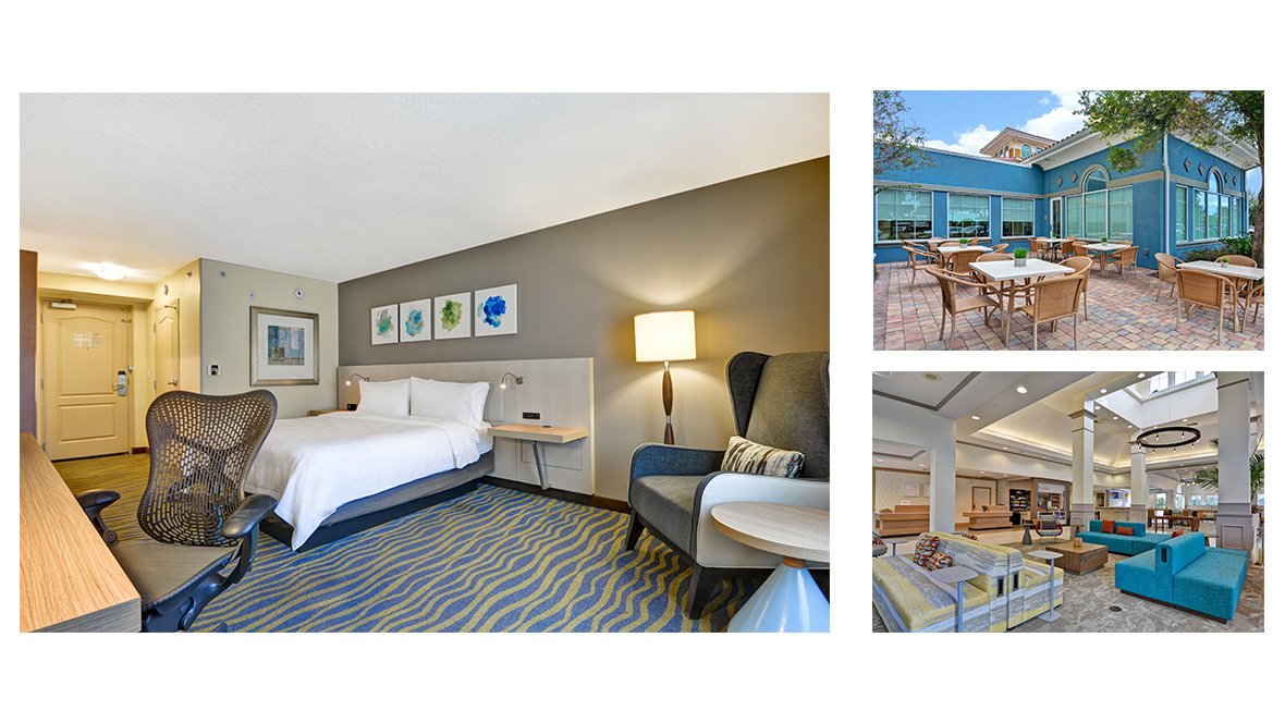 3 photos make up a collage. The left (and largest photo) features an example of a room at the Hilton Garden Inn Lake Buena Vista/Orlando. A white sheeted bed sits on blue carpet with yellow waves. Two nightstands are placed on either side of the bed with light illuminating them. Above the bed are four abstract paintings with various shades of blue & green. To the right of the room is a gray lounge chair with a small table next to it. The top right photo showcases the dining area. A patio with white tables and wicker chairs sits atop a layered brick floor. Next to these tables is a bright blue building with multiple windows that take up almost the whole wall. The bottom-right photo showcases the hotel lobby. The lobby features multicolored two-sided couches. Toward the back of the room are two lobby check-in desks and a store next to it.