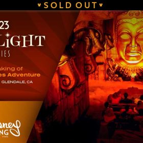 A promotional image for the D23 Spotlight Series event titled ‘The Making of Indiana Jones Adventure,’ scheduled for February 22 in Glendale, CA, presented by Walt Disney Imagineering. The background features deep red and gold tones, evoking a sense of adventure and mystery. On the right side, there is a dramatic scene from the Indiana Jones Adventure attraction with a ride vehicle filled with guests is seen entering and looking forward into the Forbidden Eye of the temple deity Mara, surrounded by fire-lit carvings and ominous red lighting. The left side of the image has a rich red gradient with golden text and accents, reinforcing the classic Indiana Jones aesthetic. A banner at the top reads SOLD OUT.