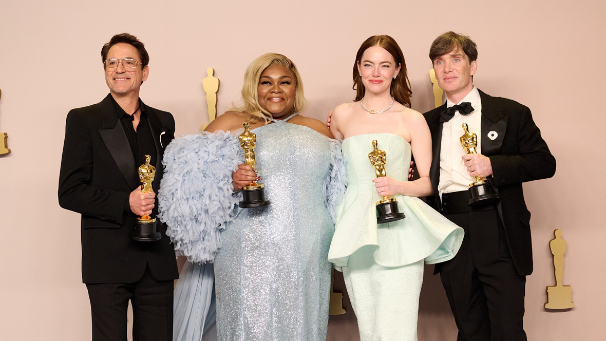 Disney Legend Robert Downey Jr., Da'Vine Joy Randolph, Emma Stone, and Cillian Murphy hold gold Oscar statues and pose for a group photo at the 96th Oscars in 2024.