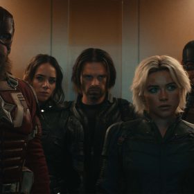 In an image from Marvel Studios’ Thunderbolts*, Red Guardian, Ghost, Bucky Barnes, Yelena Belova, and John Walker stand in a closely packed group, about to exit through the open doors of an elevator.