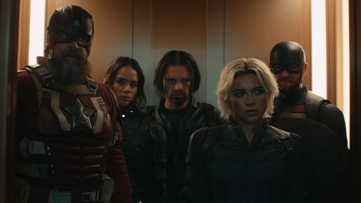 In an image from Marvel Studios’ Thunderbolts*, Red Guardian, Ghost, Bucky Barnes, Yelena Belova, and John Walker stand in a closely packed group, about to exit through the open doors of an elevator.