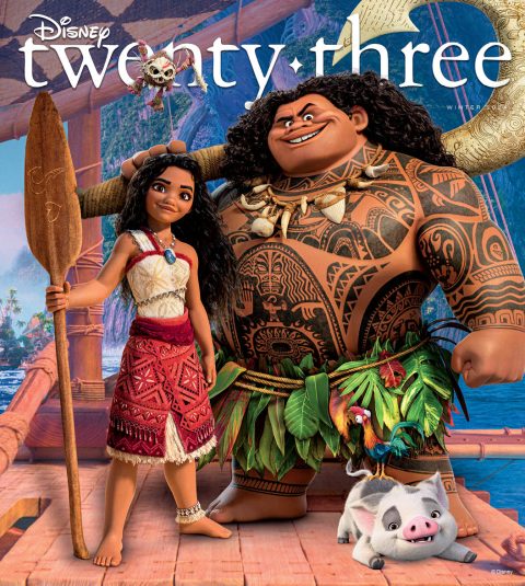 Characters from the film Moana 2, including Moana and Maui, stand on their ocean-going canoe at sea in this front cover image from the Winter issue of Disney twenty-three. A tropical island appears in the distance behind them.