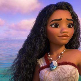 Moana from Moana 2, staring out at the ocean with a rope in her hand.