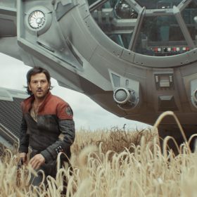 Cassian Andor (Diego Luna) stands in a field, with a ship behind him, in Andor.
