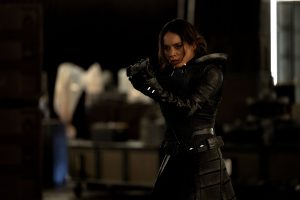 In an image from Marvel’s Thunderbolts* The New Avengers, Ava Starr (Ghost) is wearing her Super Hero suit and pointing a weapon at something off camera to the left.