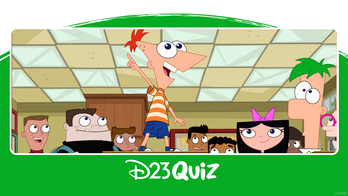 In a photo from season 5 of Phineas and Ferb, Phineas is standing on a desk and pointing, surrounded by Ferb, Isabella, Baljeet, Buford, and other students in a classroom.