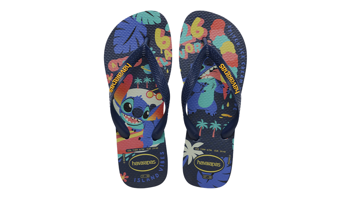 A top-down view of a pair of Havaianas flip-flops. The left slipper features Stitch on a surfboard and the right shows Stitch licking ice cream.