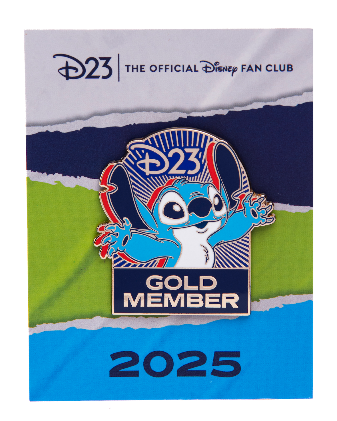 Stitch Pin The exclusive 2025 D23 Gold Member pin, featuring Stitch with his arms outstretched. The enamel pin includes the D23 logo above Stitch, and the words “Gold Member” below him. The pin is set against a background that looks like torn paper, in greens, blues, and white, with the words “D23: The Official Disney Fan Club” at the top and “2025” at the bottom.