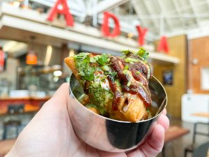A Mini Samosa Chaat with chickpeas, chutneys and cilantro from ADYA Indian Flavors.