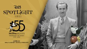 A promotional image for the D23 Spotlight Series event, “Walt Disney Archives 55th Anniversary Celebration,” taking place on June 22 at Walt Disney World Resort. The left half of the image features the D23 Spotlight Series logo on black text on a yellow background, and the 55th Anniversary logo of the Walt Disney Archives, which features a 1920s era Mickey raising a pencil towards a large “55”—and in thin smaller text, “Preserving the Magic 1970-2025.” Below that, text reads “June 22, Walt Disney World Resort.” The main part of the image, on the right, features a black-and-white photo of Walt Disney posing at the Hyperion Avenue studio lot with a Mickey Mouse plush doll manufactured by Charlotte Clark (ca. 1930). The doll has been spotlighted with a splash of colors (red, yellow, and black).