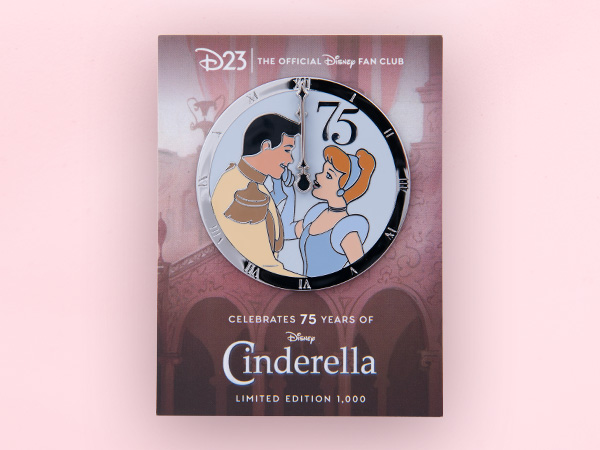 A pin celebrating the 75th anniversary of Cinderella. Cinderella, wearing her iconic blue dress, is looking up at Prince Charming, smiling. They are positioned upon a clock façade that is pointing at midnight. There is a big number 75 above Cinderella’s head.