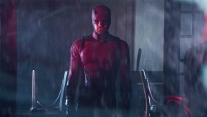Daredevil in Daredevil: Born Again, pictured in his vigilante suit through the rain at night.