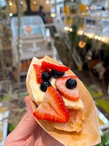 The Perfect Bite from Pique-Nique. It is a buttery slice of French Brie cheese paired with fresh summer strawberry and blueberries, drizzled in wild honey, all sat atop a slice of classic baguette. 