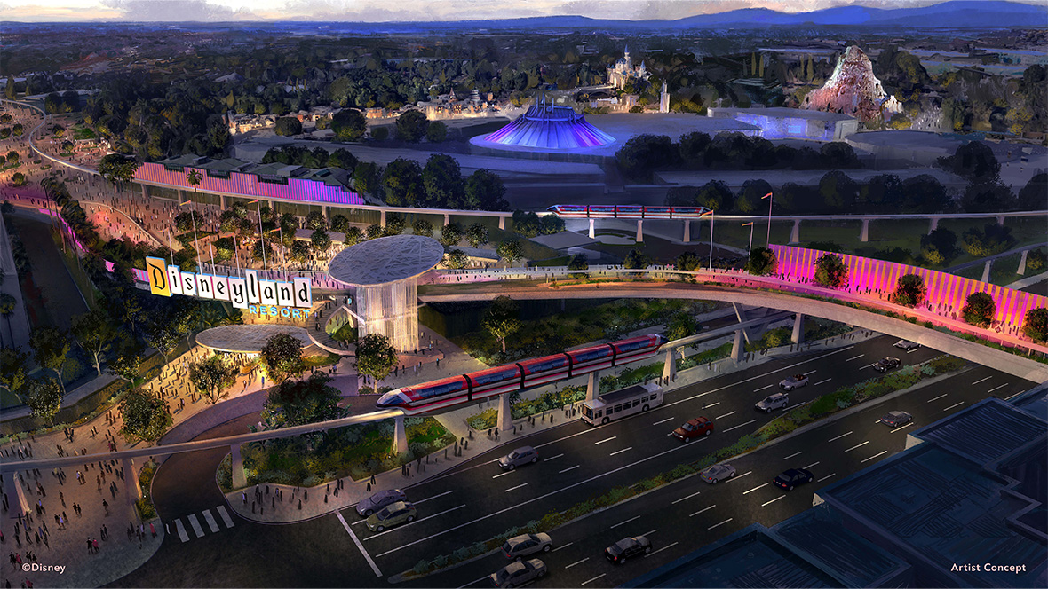 Artist rendering of a new transportation hub coming to Disneyland Resort. The hub features a red monorail and pedestrian bridge, lit up in pink lights. A pedestrian bridge is seen over a street, passing behind a sign for Disneyland Resort. In the background, attractions such as Space Mountain, Matterhorn, and Sleeping Beauty’s Castle can be seen.