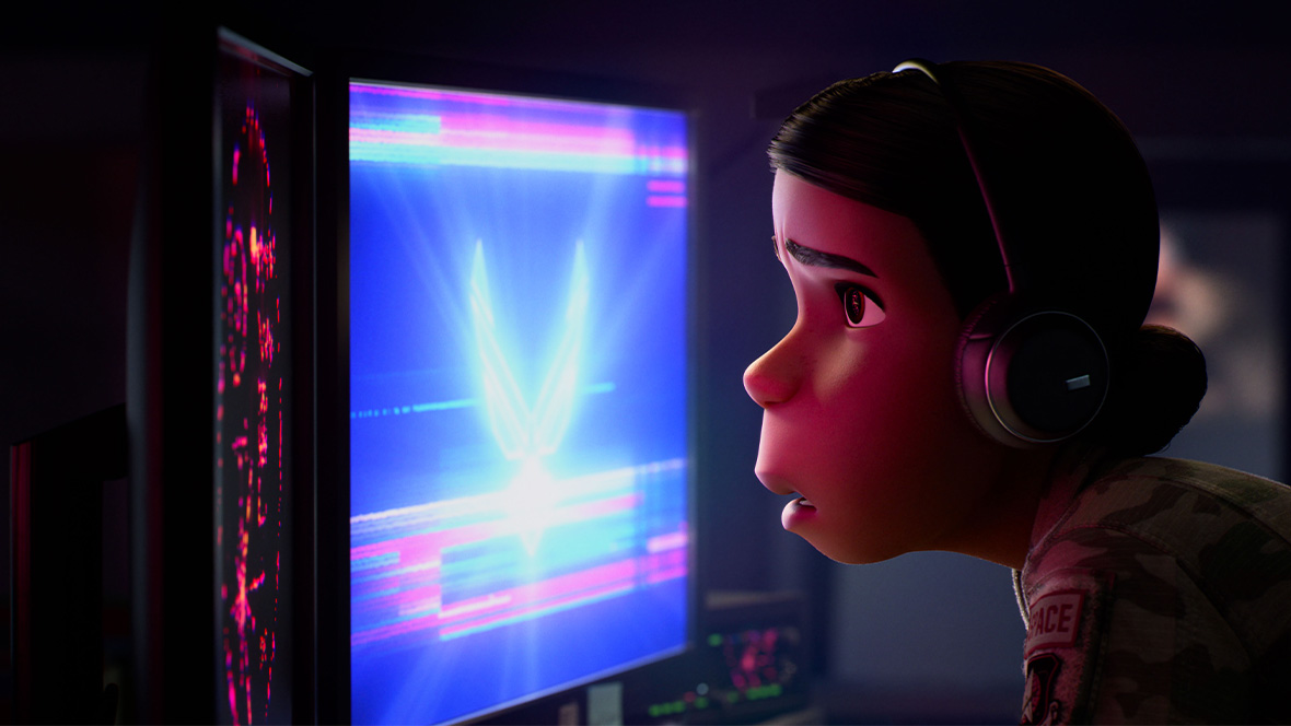 In an image from Disney and Pixar’s Elio, Aunt Olga, voiced by Zoe Saldaña, has her face close to a brightly lit computer screen and is staring at it with a concerned look. She is wearing fatigues and has headphones over her ears.