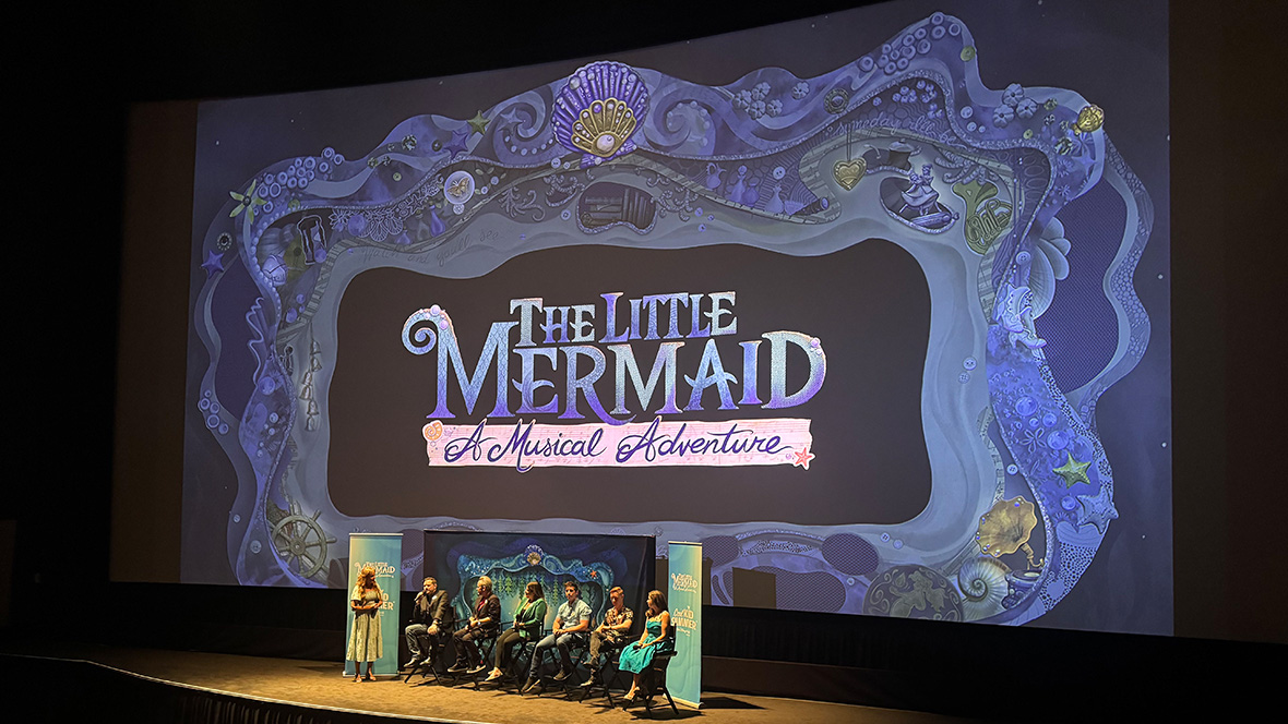 A picture of the stage at D23’s screening event of The Little Mermaid. Onstage is Jodi Benson and a panel of creatives from The Little Mermaid – A Musical Adventure against a backdrop of the new show.