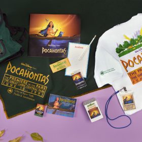 Green and white merchandise pieces from the Pocahontas premiere appear carefully placed on a purple background.