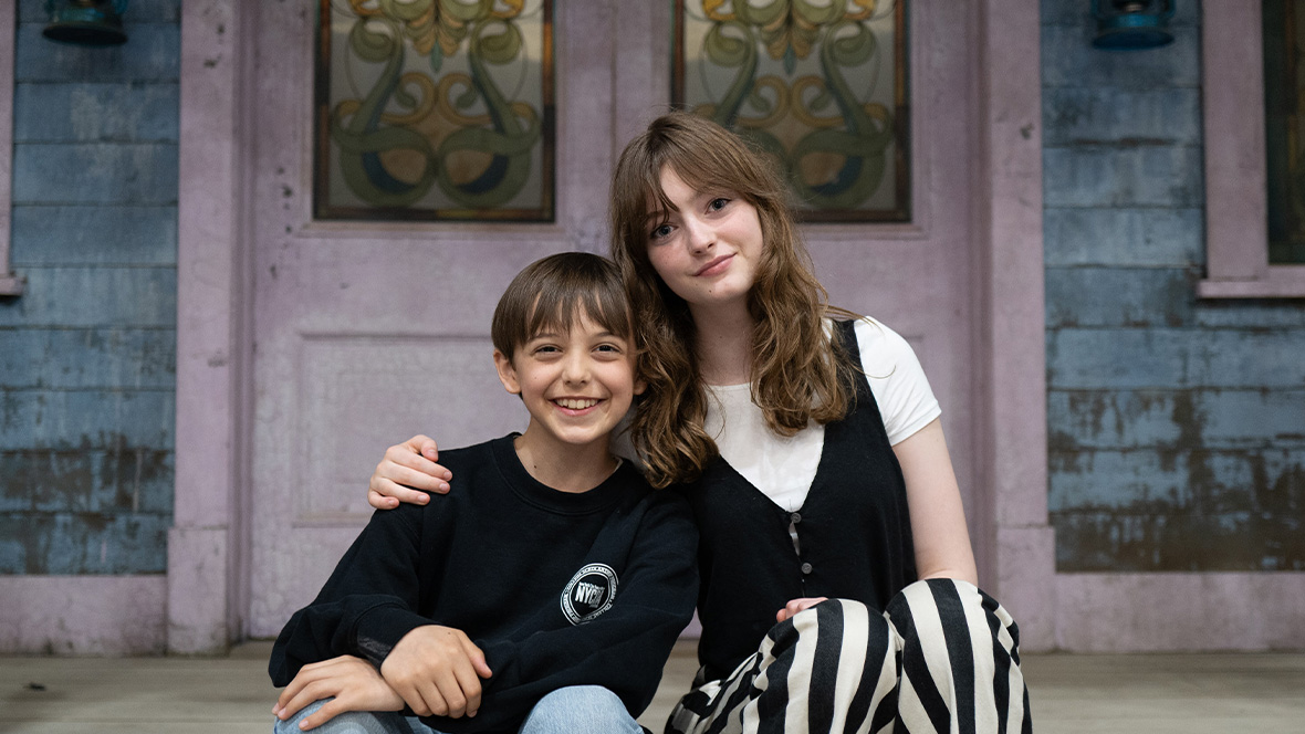Levi Chrisopulos and Olive Abercrombie sit on a front porch.