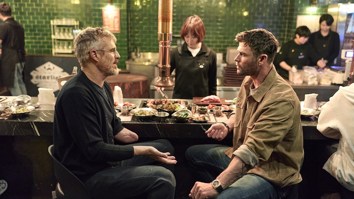 Chris Hemsworth (right) and Dr. B.J. Miller (left) sharing a meal in South Korea in the series Limitless: Live Better Now.