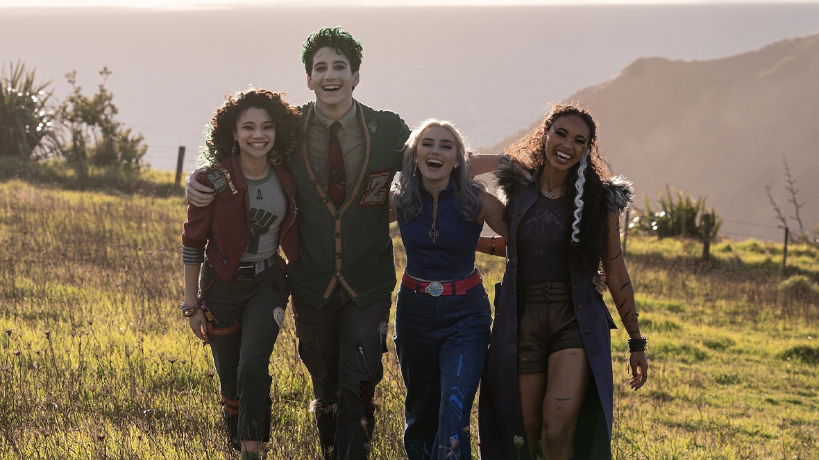 Zombie Eliza (Kylee Russell), zombie Zed (Milo Manheim), alien Addison (Meg Donnelly), and werewolf Willa (Chandler Kinney) embrace atop Mount Rayburn in the Disney Channel Original Movie ZOMBIES 4: Dawn of the Vampires.