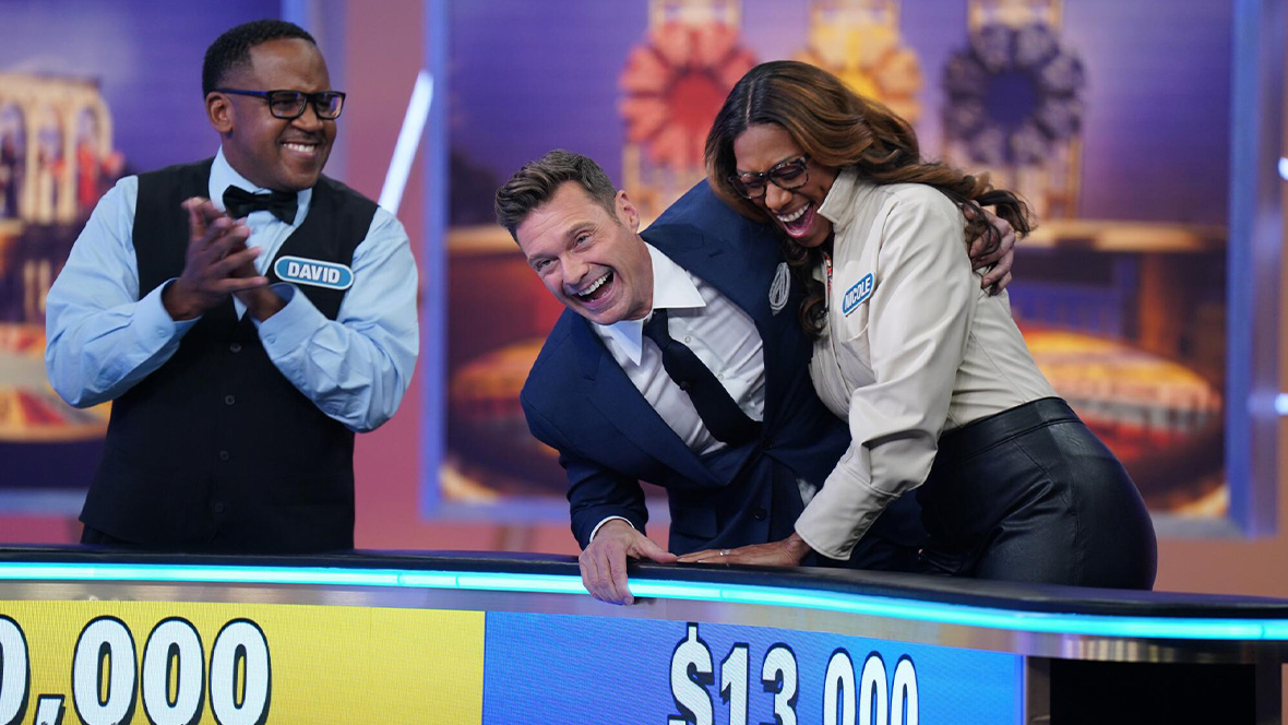 Contestants and Ryan Seacrest on Wheel of Fortune