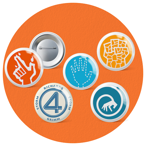 Fantastic Four Set of five collectible button badges inspired by the Fantastic Four—each representing a team member’s powers or logo, placed on an orange background.