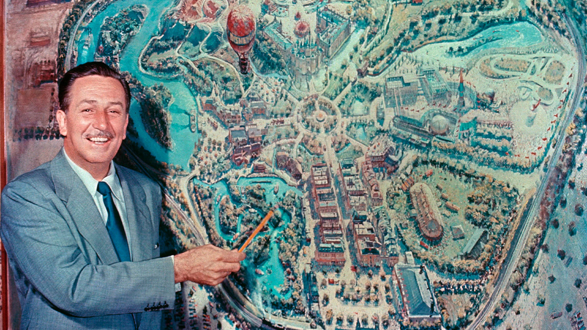 Walt Disney with an early map of Disneyland.