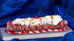 Collage with two images of churros. On the left, a Banana Split Churro rolled in chocolate sugar and topped with banana sauce, vanilla saucer, and a cherry. On the right, a 70th Celebration Churro rolled in ube sugar and topped with marbles blue raspberry icing drizzle and sprinkles.