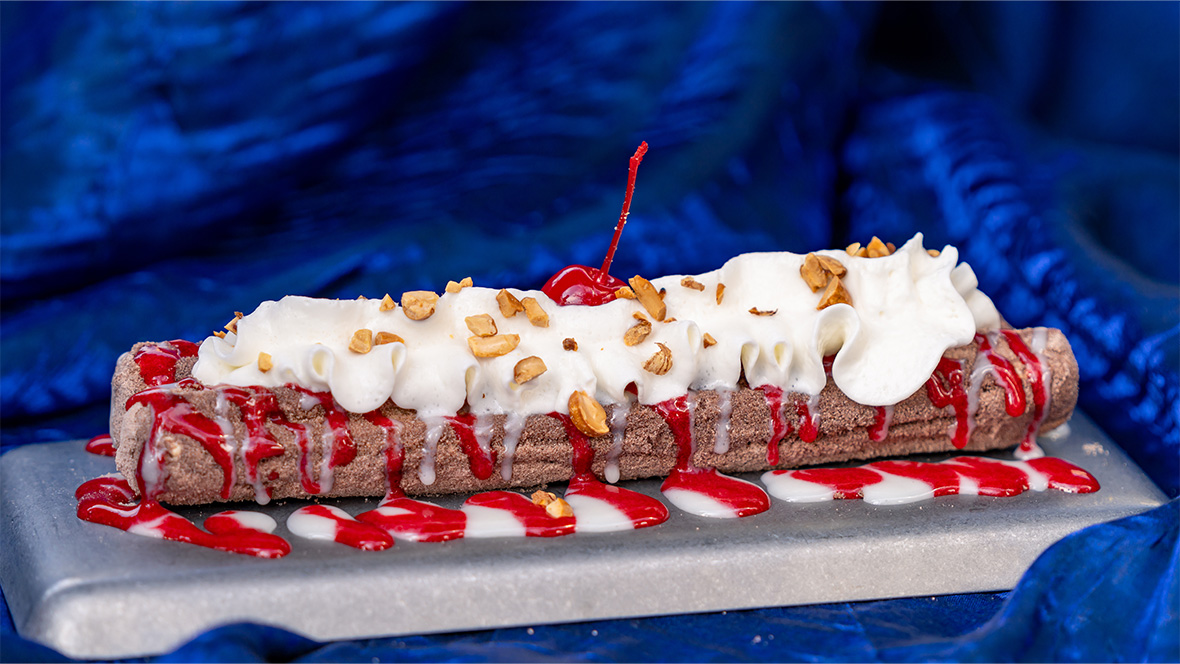 Collage with two images of churros. On the left, a Banana Split Churro rolled in chocolate sugar and topped with banana sauce, vanilla saucer, and a cherry. On the right, a 70th Celebration Churro rolled in ube sugar and topped with marbles blue raspberry icing drizzle and sprinkles.