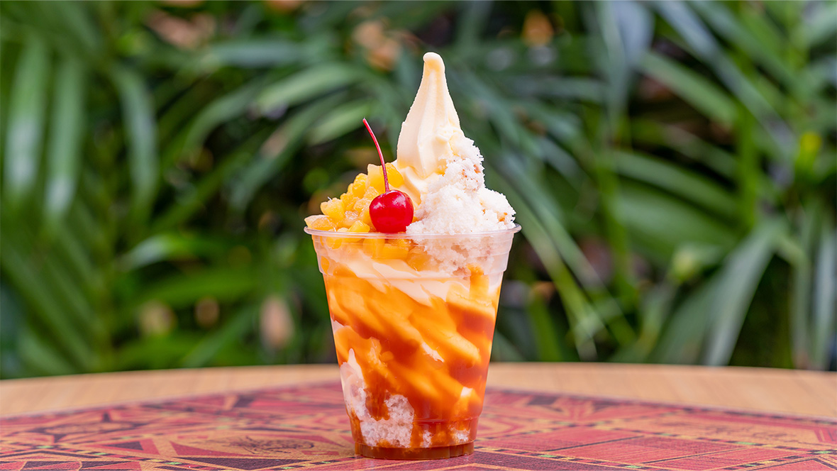 DOLE Whip® Pineapple served with a caramel drizzle, pineapple upside-down cake, and a maraschino cherry, available at the Tropical Hideaway at Disneyland Park.