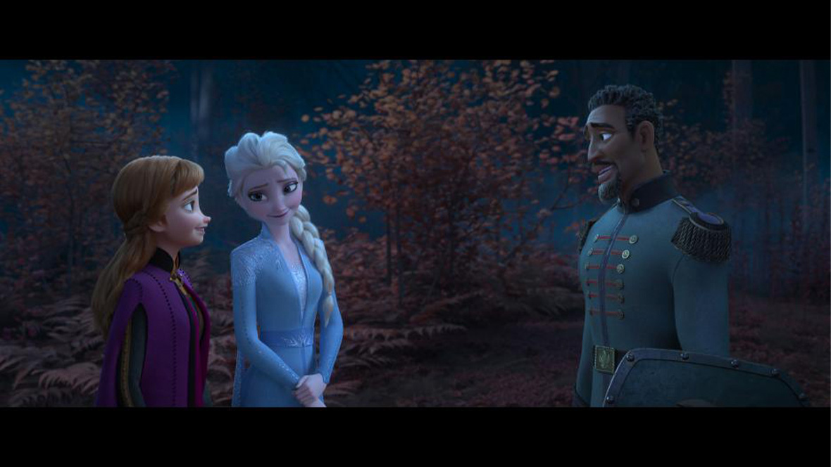 Anna and Elsa stand in the enchanted forest with lieutenant Destin Mattias.