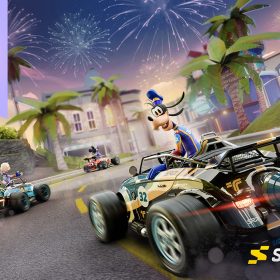 In an image from Disney Speedstorm, Goofy is wearing the Disneyland 70th Celebration racing suit in a kart racing on a road with Donald Duck and Mickey Mouse in front of him with their own Disneyland 70th Celebration racing suits. The Disneyland 70th logo is in the top left corner with the pink castle outline and number 70 that is blue and purple. There are green palm trees and buildings in the background with fireworks in the sky.
