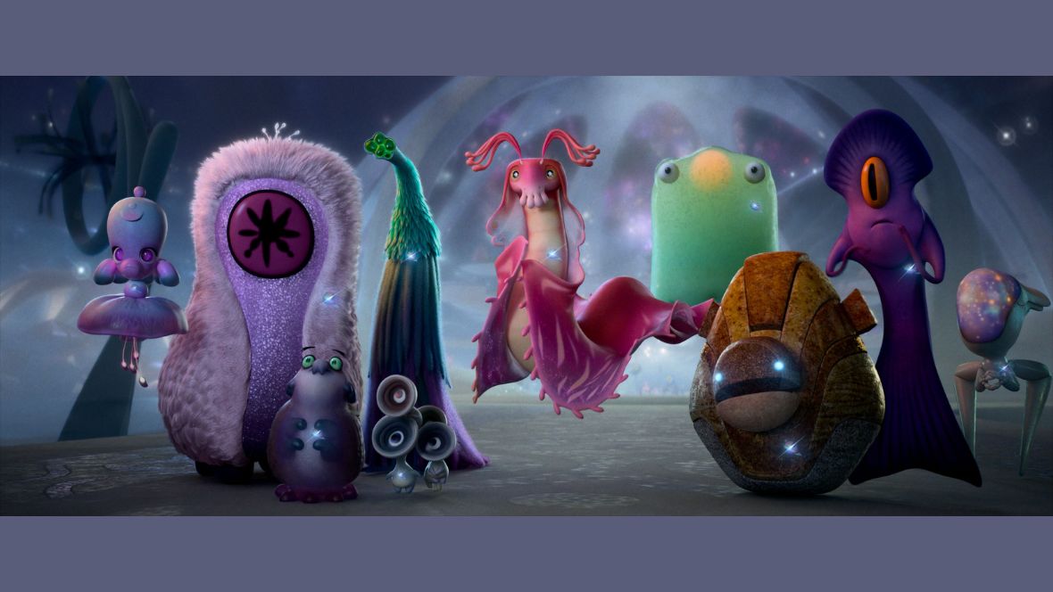 In a still from Disney and Pixar’s Elio, several Ambassadors of the Communiverse are seen standing side-by-side, including (from left to right) Ambassador Mira, who looks a little bit like a pink poodle; Ambassador Auva, a large pink alien with a red face; Ambassador Helix, a pink roly-poly little alien with green eyes; Ambassador Questa, who resembles a leafy sea dragon; Ambassador Tegman, whose configuration resembles floating boulders; and Ambassador Turais, a thin purple alien.