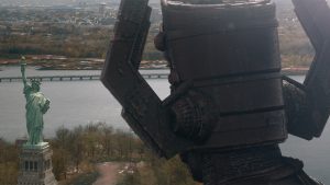 Galactus in Marvel Studios’ The Fantastic Four: First Steps. The back of his head is seen as he towers over the Statue of Liberty.