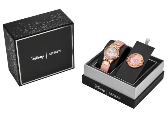 Images are shown of Citizen’s Belle, Eternal Beauty Watch Box Set: on the left, there is a black box with Disney Logo alongside a Citizen logo, both written in white. On the right, there is another Disney Citizen branded black box, this one open and showing just the bottom half, with Disney and Citizen logos in white writing. In the box is the Citizen Watch Belle, Eternal Beauty. It is rose gold with Belle on it.
