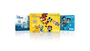 Disney Visa promotional image – a set of three Disney Premier Chase Visa cards. From left to right, the first is -Walt Disney World themed, the second features Mickey, Minnie, Goofy, Daisy, Donald, and Pluto, and the third features Buzz Lightyear, Woody, and Jessie.