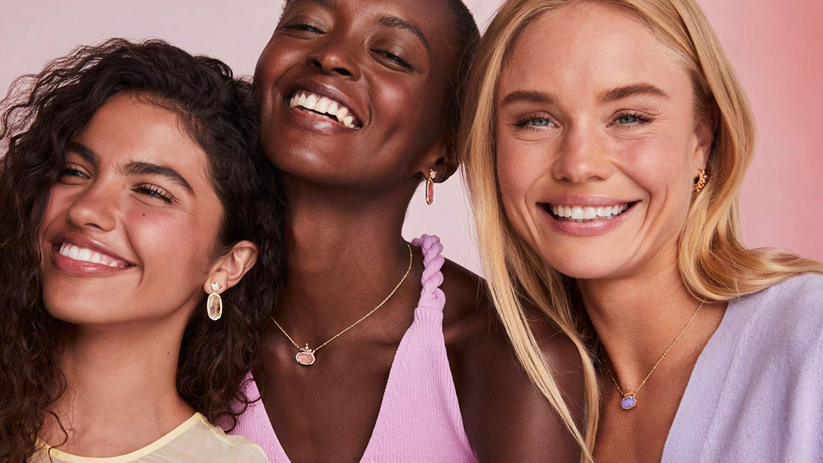 GOLD MEMBER OFFER: 15% Off Eligible Purchase During Destination D23 at Kendra Scott, Disney Springs Three women all stand together wearing Kendra Scott earrings and necklaces from the Princess Collection. The woman on the left and the woman in the center smile at something off-camera; the woman in the right is smiling while looking right into the camera.