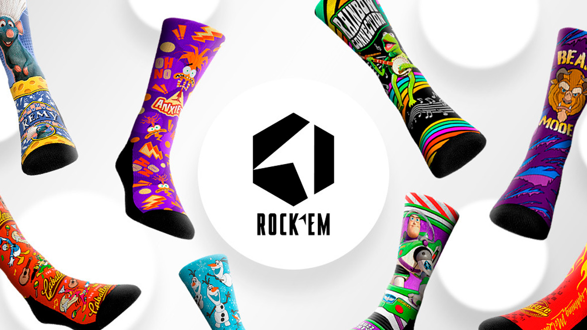 Colorful Rock 'Em Socks featuring various Disney and Pixar characters and designs, including Remy from Ratatouille, Kermit the Frog, Beast from Beauty and the Beast, Olaf from Frozen, Buzz Lightyear from Toy Story, and others, arranged in a circular layout around the Rock 'Em logo