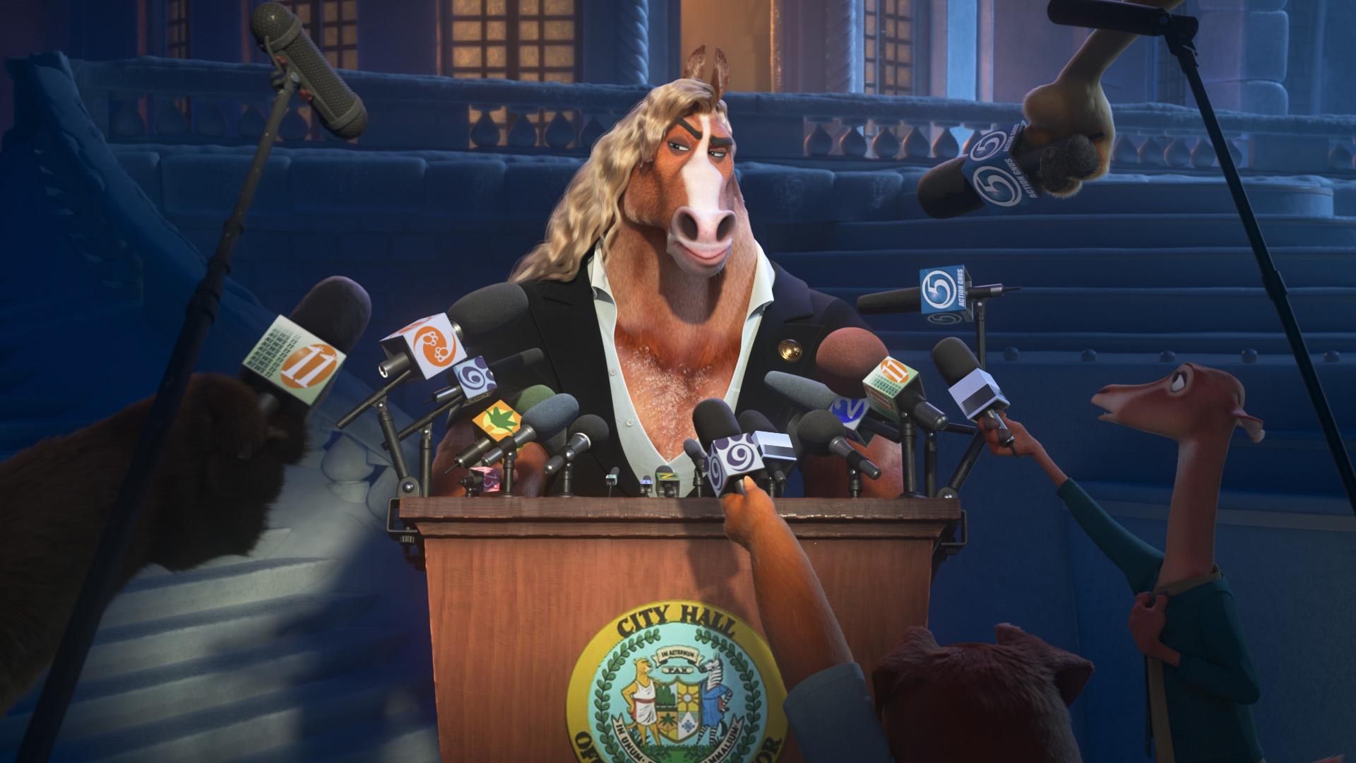 In a scene from Zootopia 2, a horse with long, golden hair in place of a mane stands behind a podium that holds about two dozen microphones; more microphones are held up by reporter animals in front of and to the side of the podium. The horse has a suspicious look on his face and appears to be wearing a black sport coat on top of a gray shirt with a low V-neck, exposing the white hair on the horse’s chest. Behind the horse and podium, barely visible in the dark, are stairs leading to a Roman-style balcony and a building with windows that glow a dull yellow.