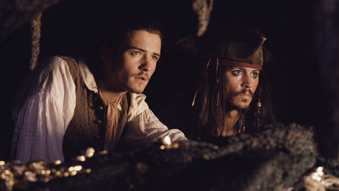 Will Turner (played by Orlando Bloom, left) and Captain Jack Sparrow (played by Johnny Depp, right) in Pirates of the Caribbean: The Curse of the Black Pearl
