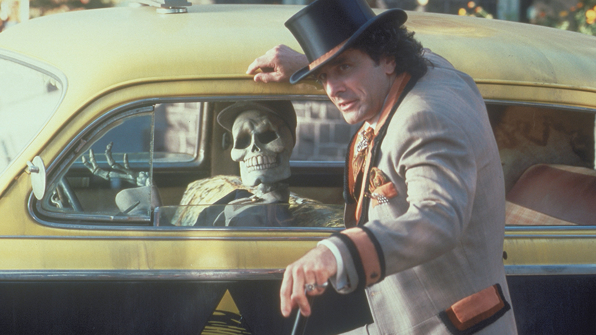 Kalabar (played by Robin Thomas, right) giving directions to a skeleton driving a yellow cab in Halloweentown