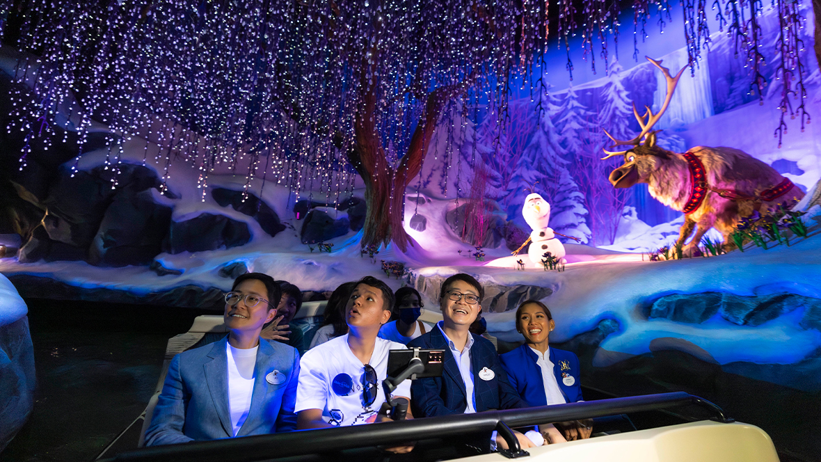 Cast members ride the Frozen attraction at Hong Kong Disneyland.