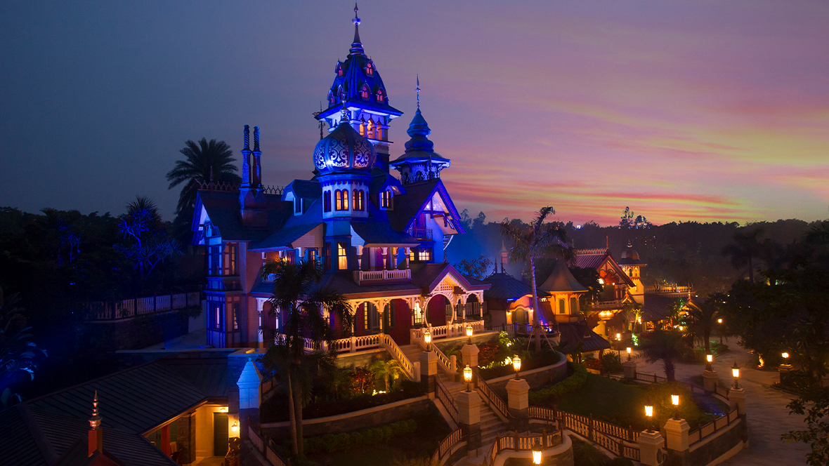 An image of Mystic Manor at Hong Kong Disneyland at nighttime.