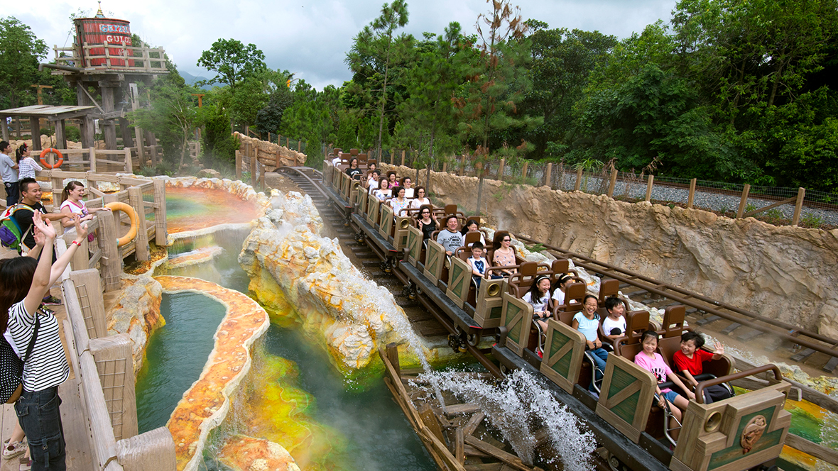 An image of Big Grizzly Mountain Runaway Mine Cars at Hong Kong Disneyland, during the daytime. Guests are riding in the cars and enjoying the attraction.
