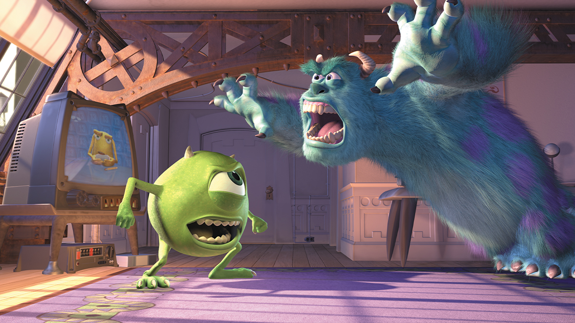 Mike Wazowski (left) coaching his, Sully (right), to be scarier as he roars in Monsters, Inc.