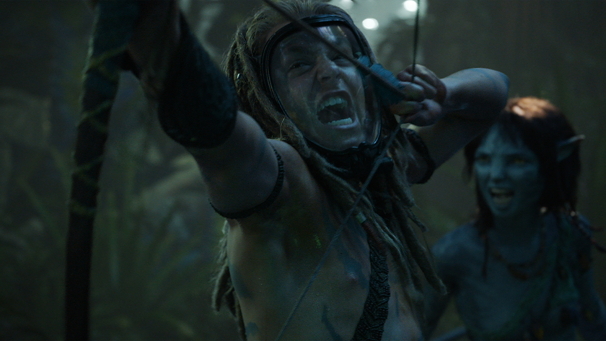 Spider (Jack Champion) pulls a bow as Kiri (Sigourney Weaver) snarls.