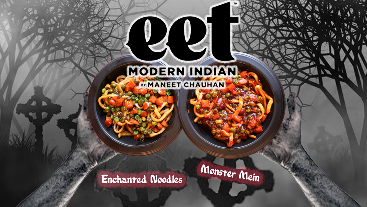Two gray hands hold seasonal dishes from eet by Maneet Chauhan, the Enchanted Noodles and the Monster Main, against a gray backdrop of gravestones and trees.