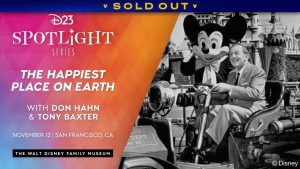 A promotional image for D23’s Spotlight Series event, The Happiest Place on Earth at The Walt Disney Family Museum, taking place on November 12, 2025 in San Francisco, California, with Don Hahn, Tony Baxter, and the Walt Disney Family Museum. The left half of the image features a stylized background, a geometric blend of pinks, purples, blues, and oranges reminiscent of the cover design of Don Hahn and Christopher Merritt’s book, The Happiest Place on Earth. On the right is a black-and-white photograph of Mickey Mouse and Walt Disney in a vehicle in front of Sleeping Beauty Castle at Disneyland.
